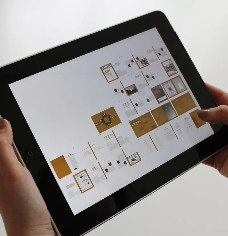 Hands holding a tablet showing a grid of page layouts